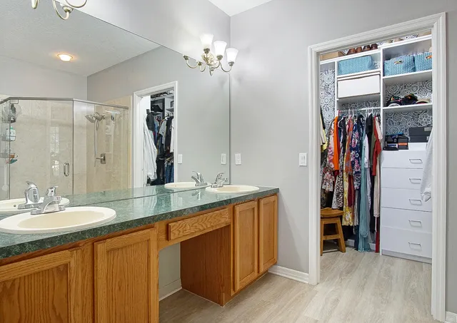 a bathroom with a double vanity sink and a mirror