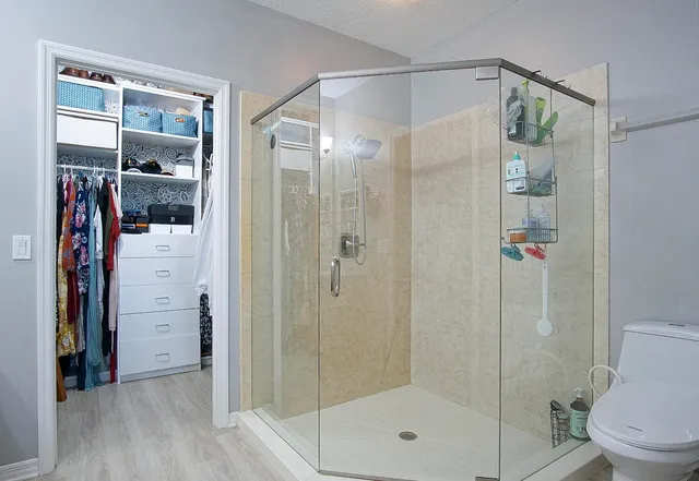 a bathroom that has a glass shower door