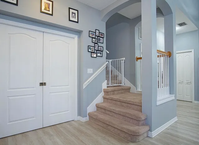 a view of entryway and hall with wooden floor