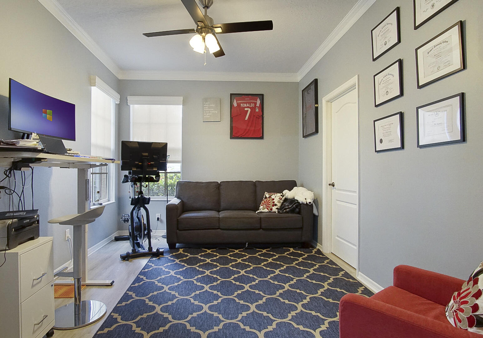 1581 Southwest Harbour Isles Circle, Unit 58 Port St. Lucie, FL 34986 - Photo 17 of 38 a living room with furniture a flat screen tv and a window