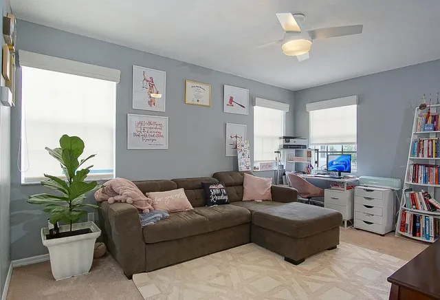 a living room with furniture potted plant and a window