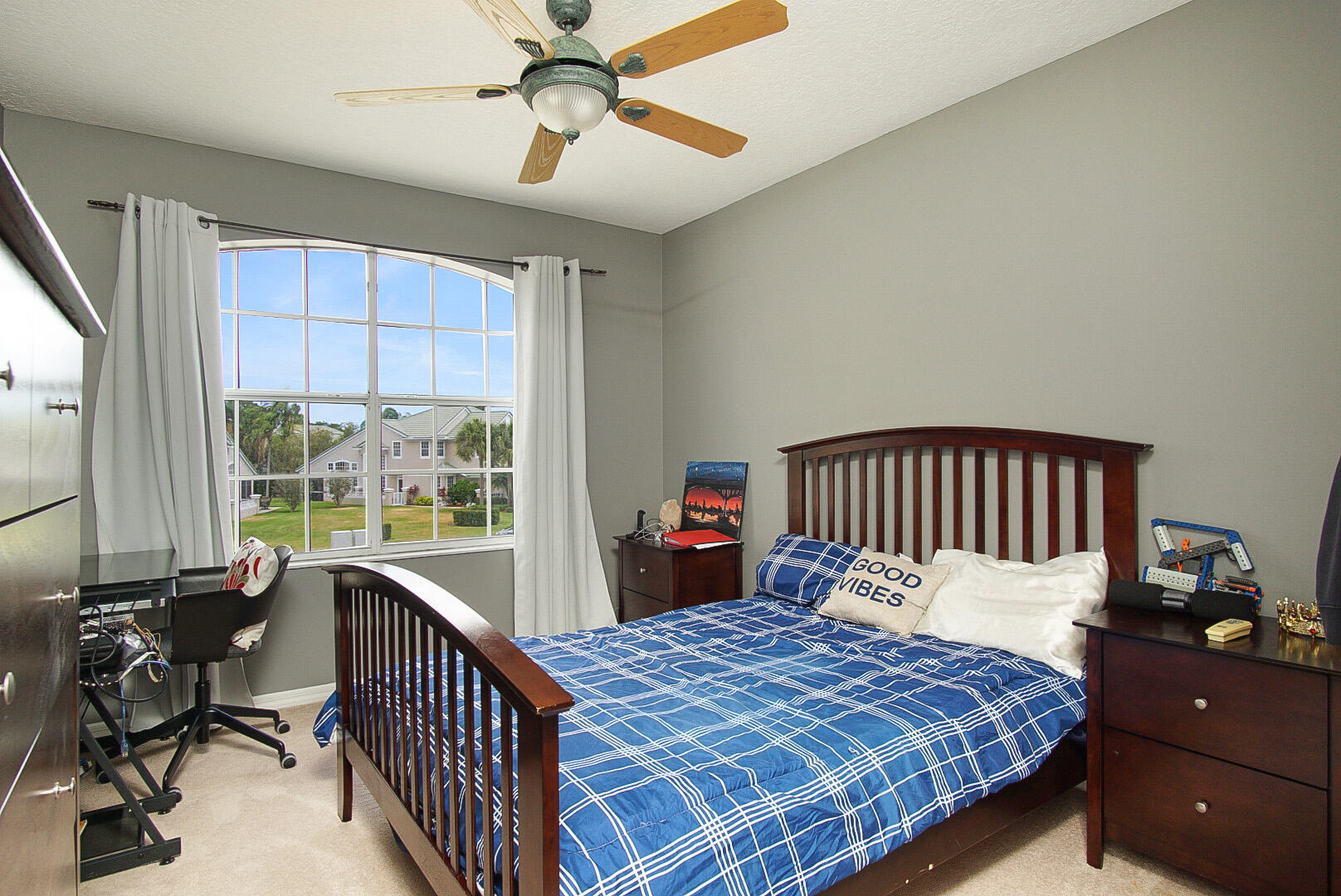 1581 Southwest Harbour Isles Circle, Unit 58 Port St. Lucie, FL 34986 - Photo 21 of 38 a bedroom with a bed and a large window
