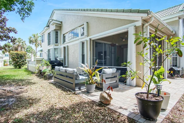 a view of a house with backyard and sitting area