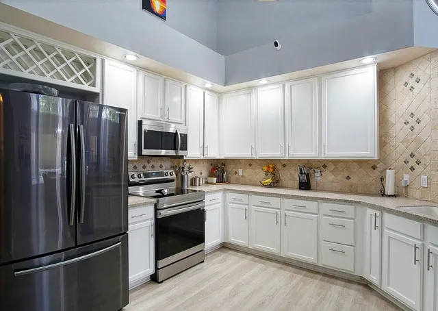 a kitchen with stainless steel appliances a refrigerator stove and sink