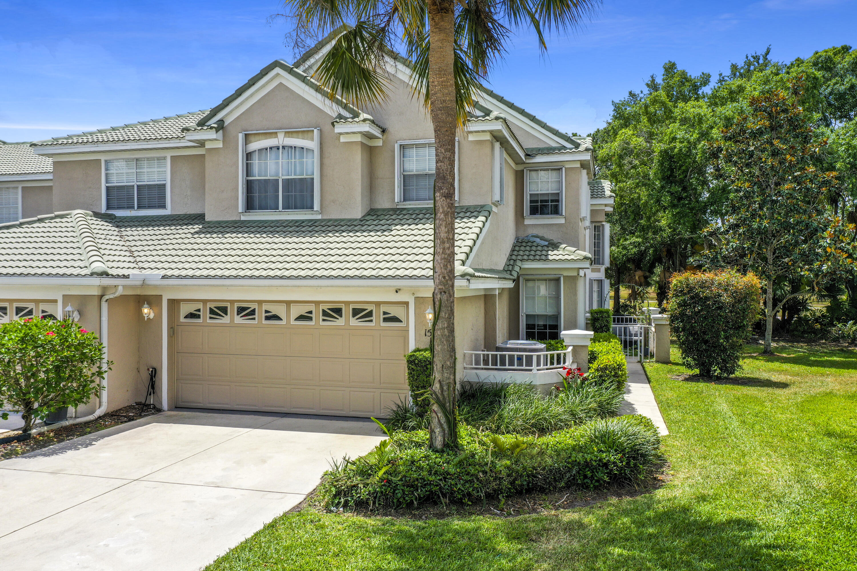 1581 Southwest Harbour Isles Circle, Unit 58 Port St. Lucie, FL 34986 - Photo 32 of 38 a front view of a house with a yard