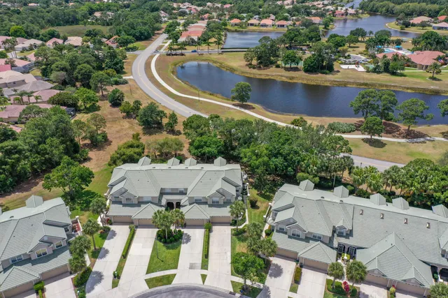 an aerial view of a house with a yard and lake view