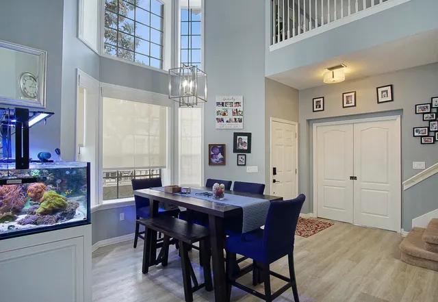 a view of a dining room with furniture and chandelier