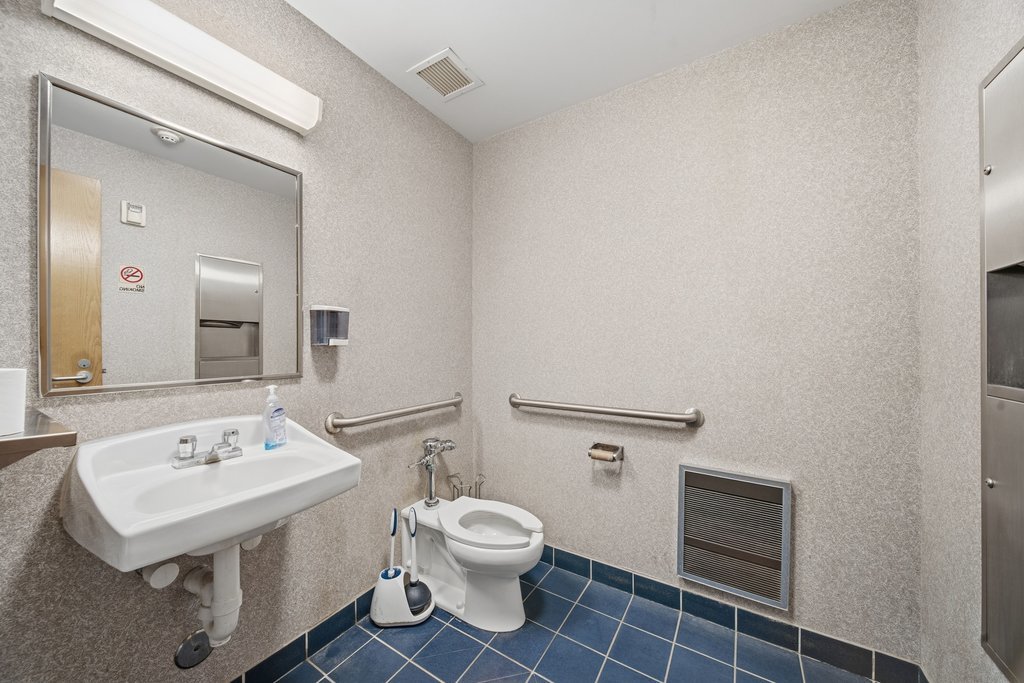 921 South State Street Lockport, IL 60441 - Photo 16 of 28 a bathroom with a toilet a sink and mirror