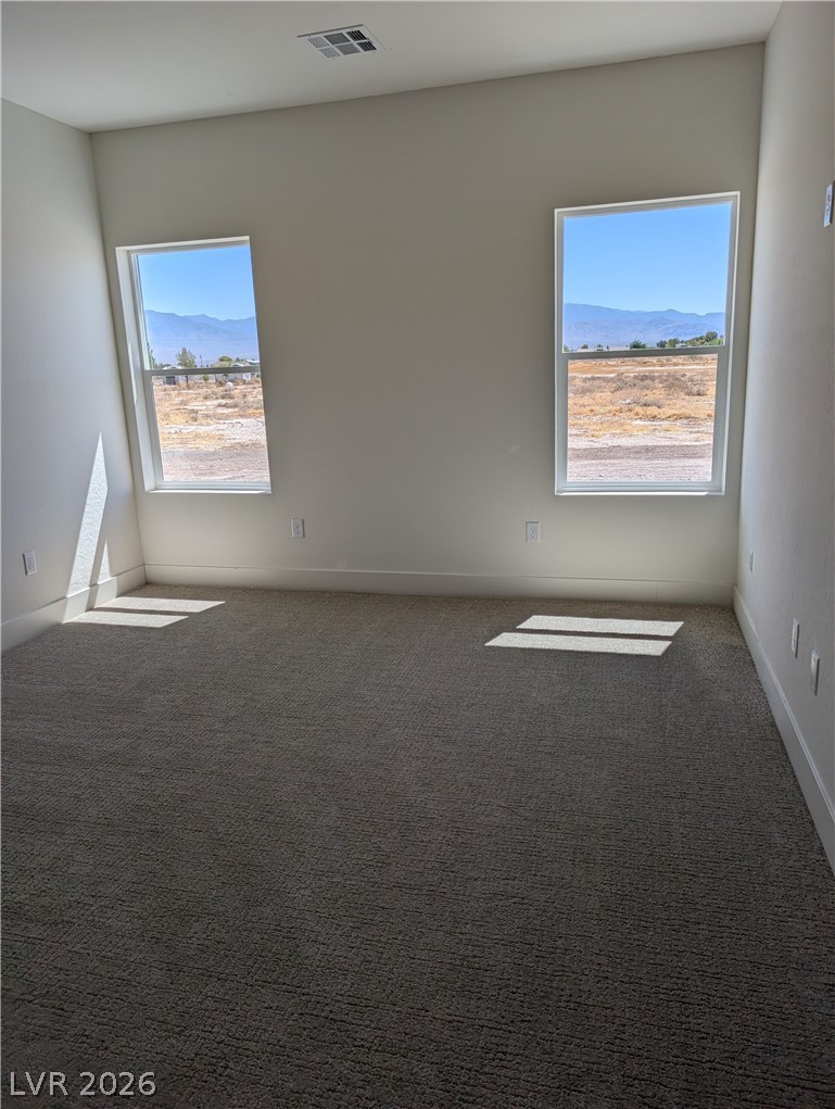 4670 Medicine Man Road Pahrump, NV 89048 - Photo 21 of 36 Floor-to-ceiling windows offer panoramic views of distant mountains and wide-open spaces.