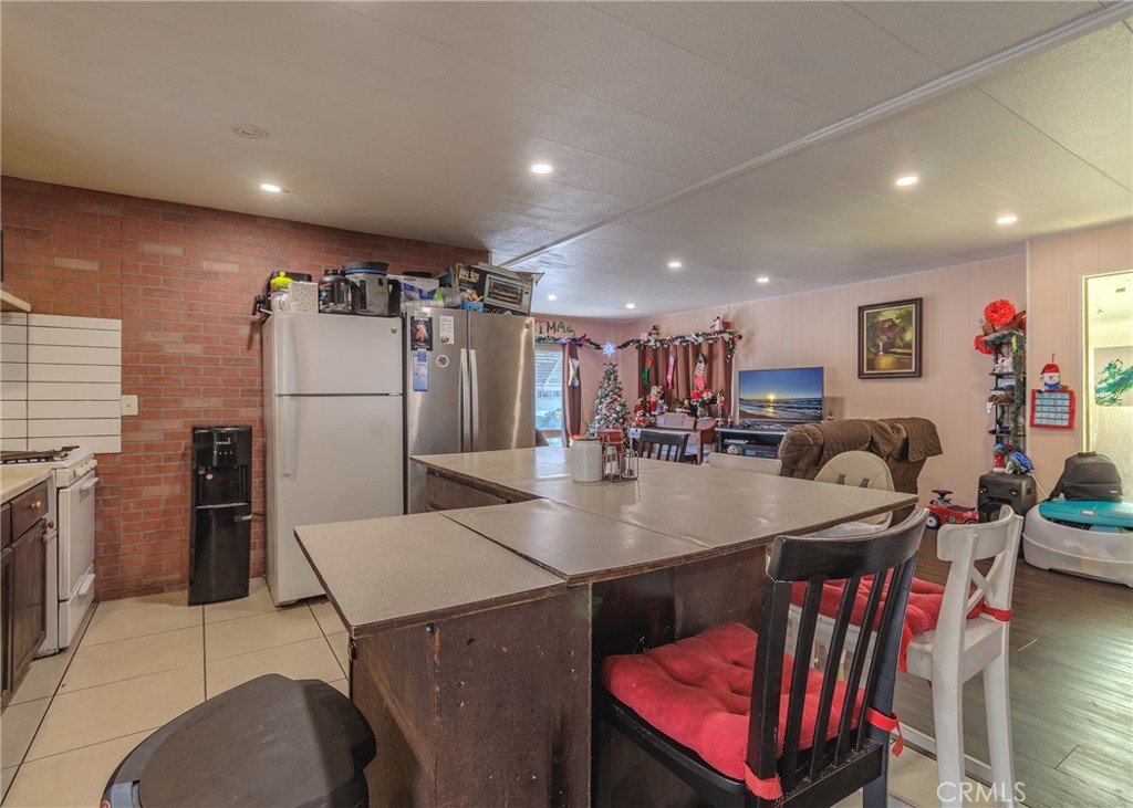 1616 South Euclid Street Anaheim, CA 92804 - Photo 7 of 22 a kitchen with stainless steel appliances granite countertop a sink a refrigerator and a stove