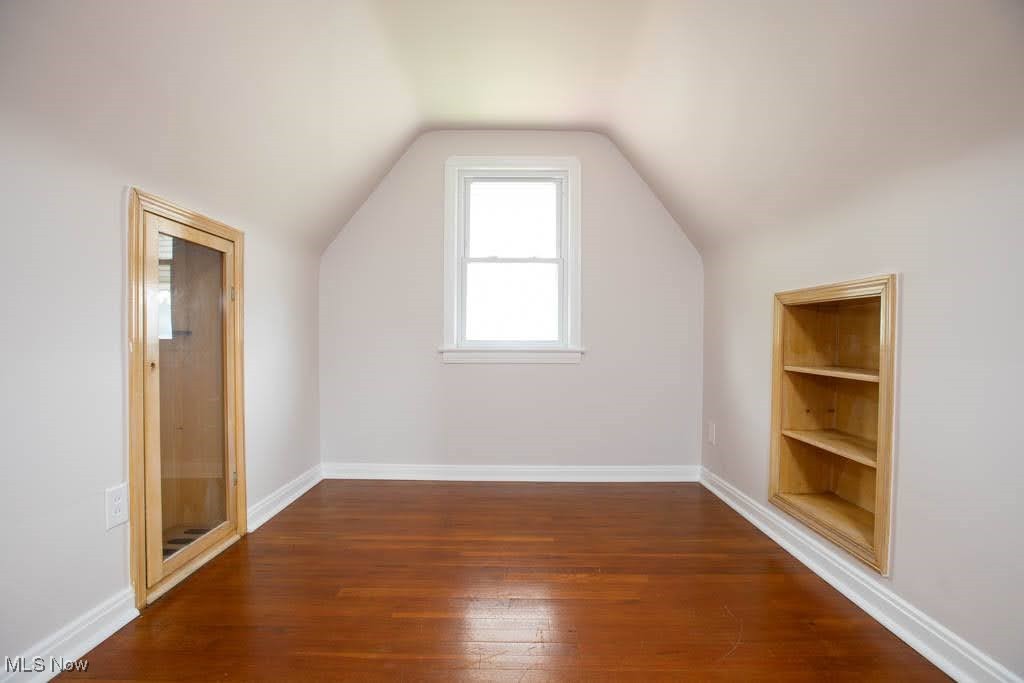 12822 Grannis Road Cleveland, OH 44125 - Photo 18 of 44 Bonus room with built in features, lofted ceiling, and hardwood / wood-style floors