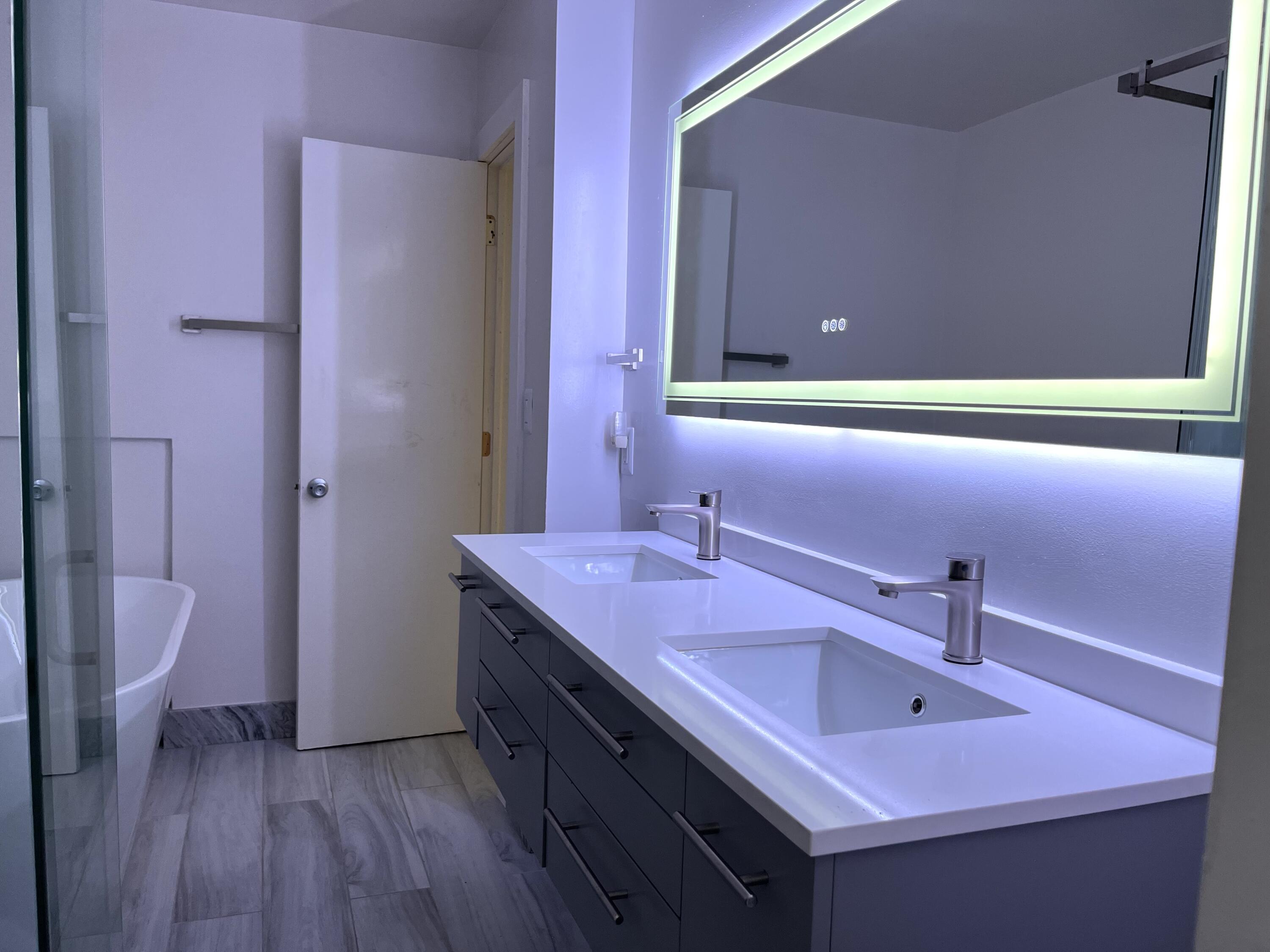 8760 Southwest 83rd Street Miami, FL 33173 - Photo 15 of 24 a bathroom with a sink and a mirror