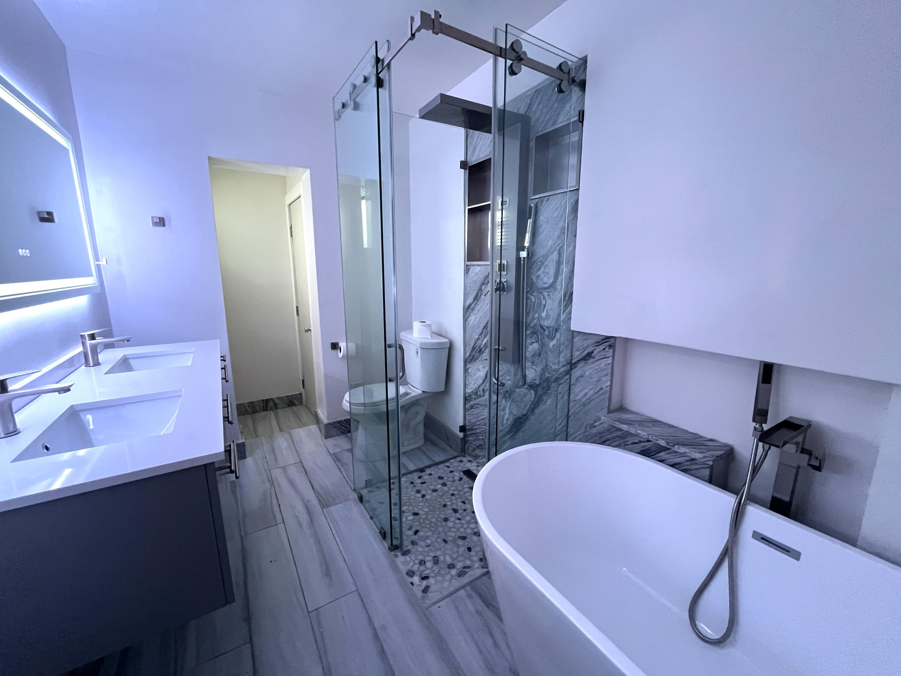 8760 Southwest 83rd Street Miami, FL 33173 - Photo 16 of 24 a bathroom with a tub sink and mirror