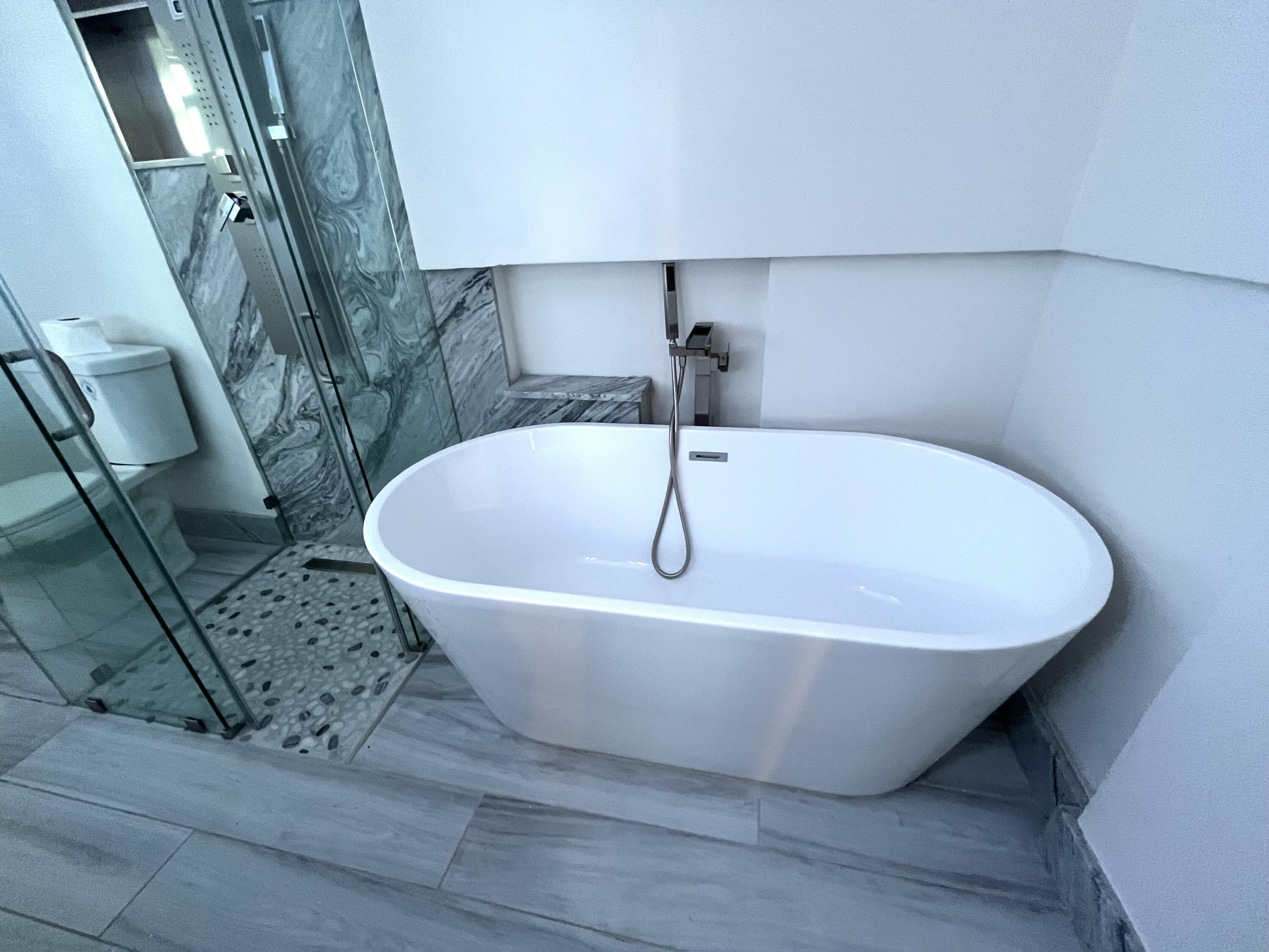 8760 Southwest 83rd Street Miami, FL 33173 - Photo 17 of 24 a white bath tub sitting in a bathroom
