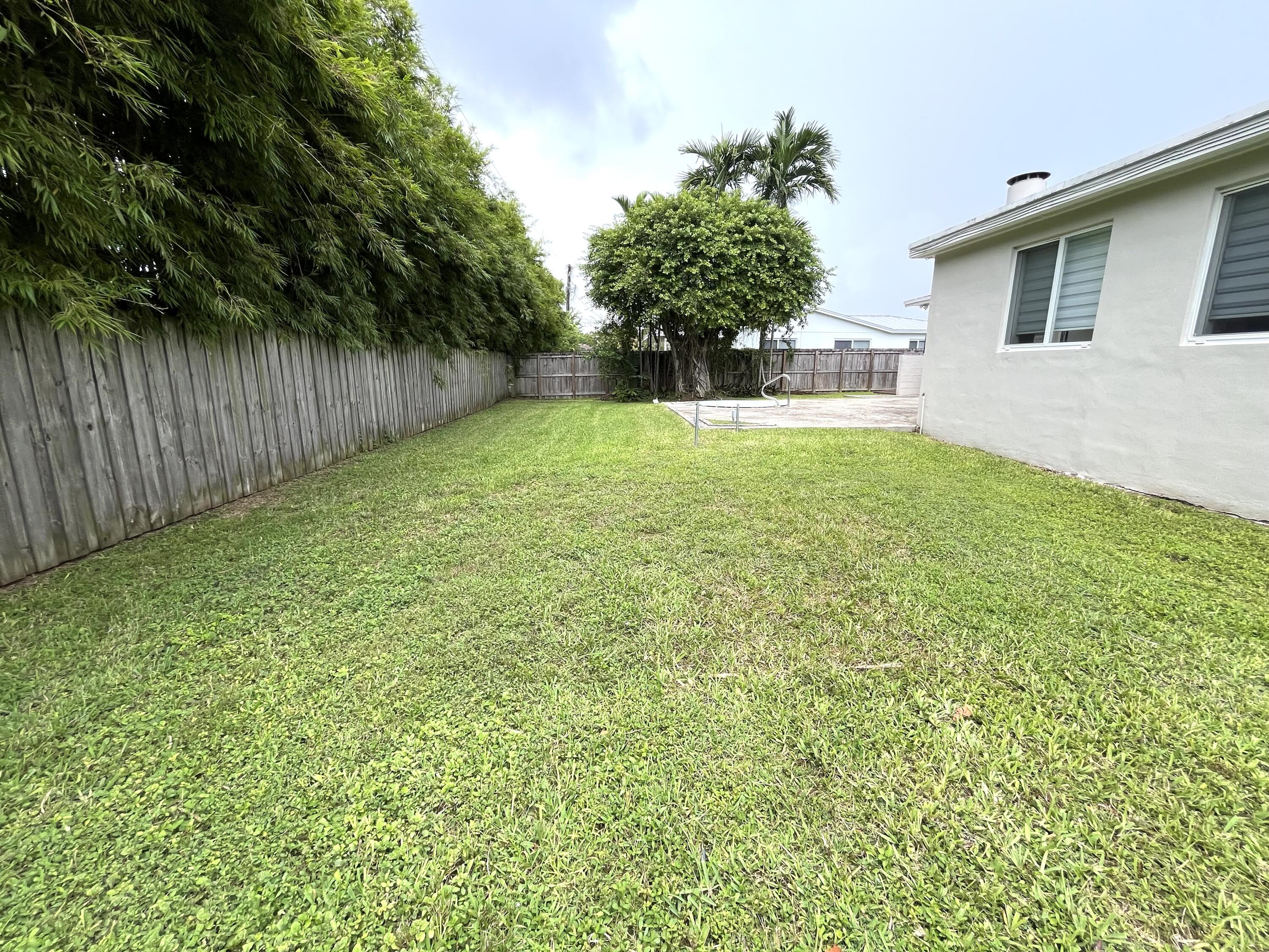 8760 Southwest 83rd Street Miami, FL 33173 - Photo 20 of 24 a view of a backyard with a plants and trees