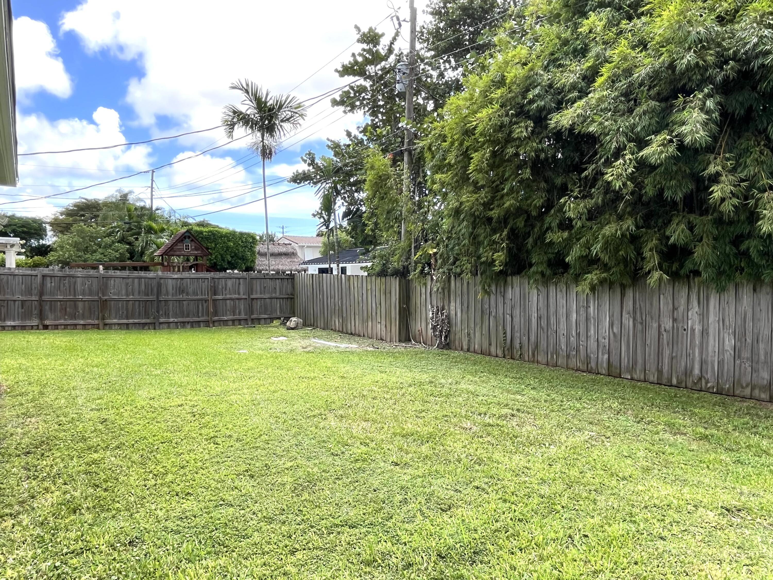 8760 Southwest 83rd Street Miami, FL 33173 - Photo 22 of 24 a view of a yard with a trampoline