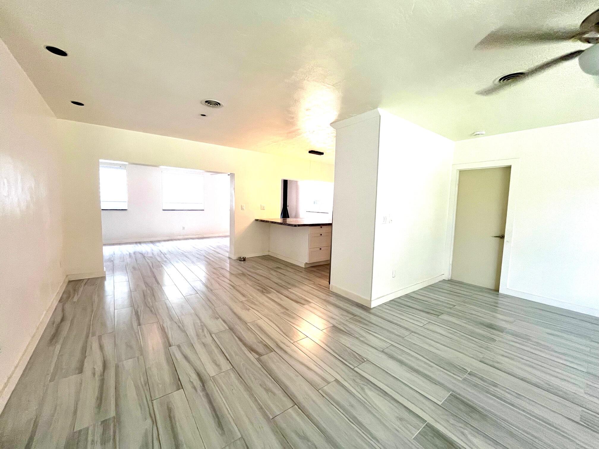 8760 Southwest 83rd Street Miami, FL 33173 - Photo 10 of 24 an empty room with wooden floor and windows
