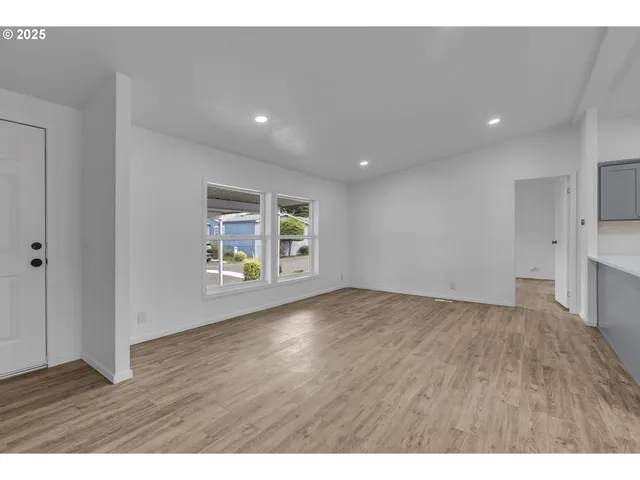 a view of a kitchen with a sink and wooden floor