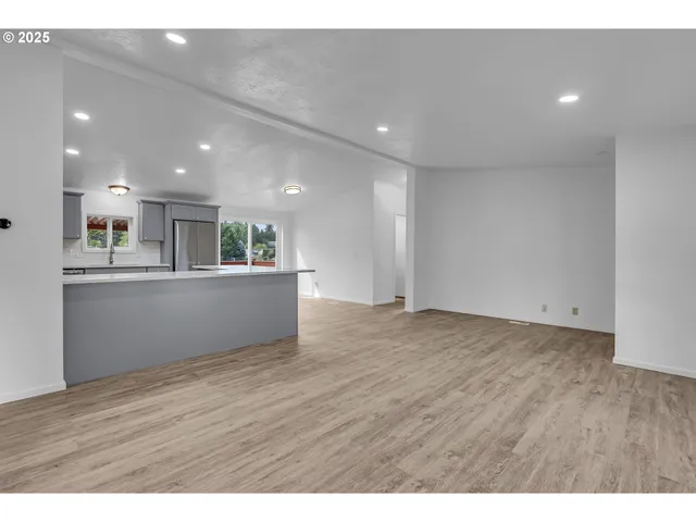 a large kitchen with kitchen island a sink a center island and stainless steel appliances