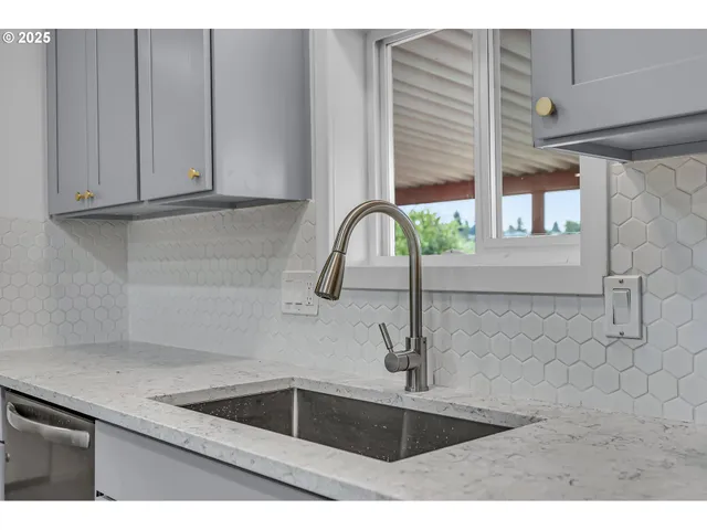 a kitchen with a sink cabinets and wooden floor