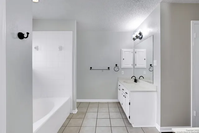 a bathroom with a bathtub and a sink
