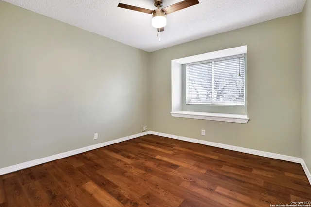 wooden floor in an empty room with a window