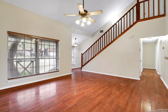 wooden floor in an empty room with a window