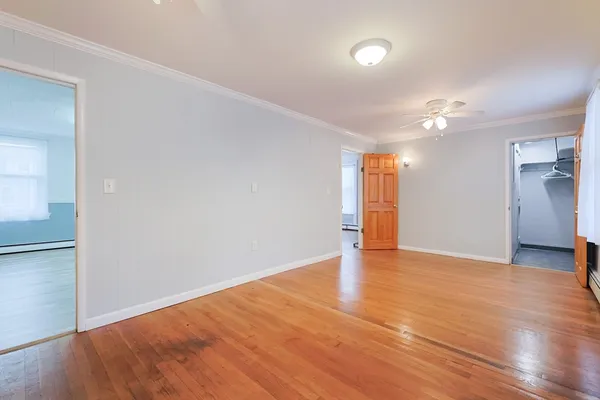 wooden floor in an empty room with a window