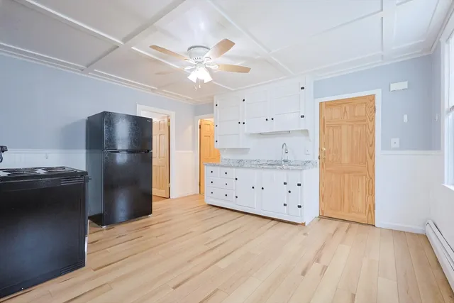 a kitchen with stainless steel appliances a stove refrigerator and cabinets