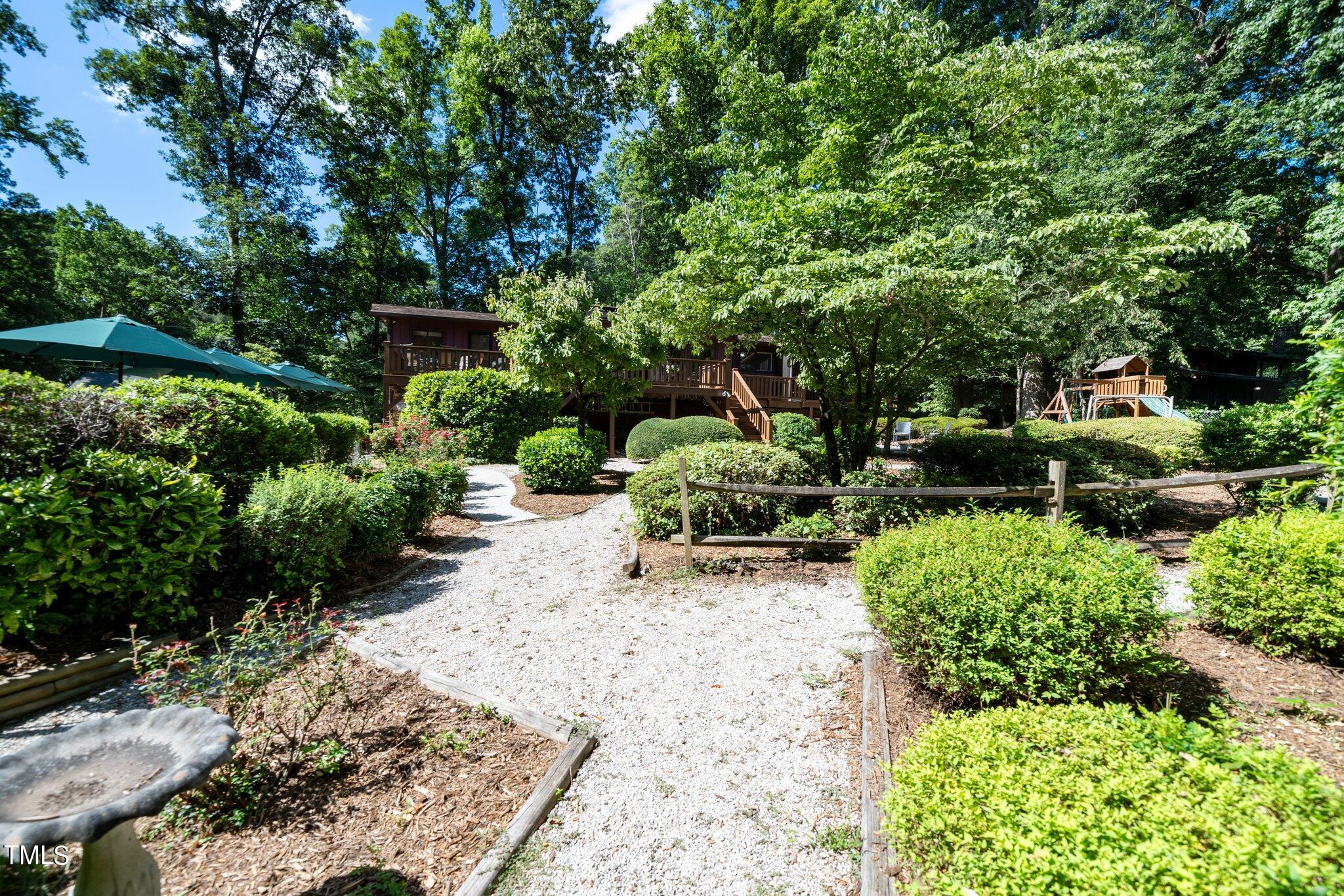 6406 Arnold Road Raleigh, NC 27607 - Photo 11 of 44 a view of a backyard with chairs and a small yard