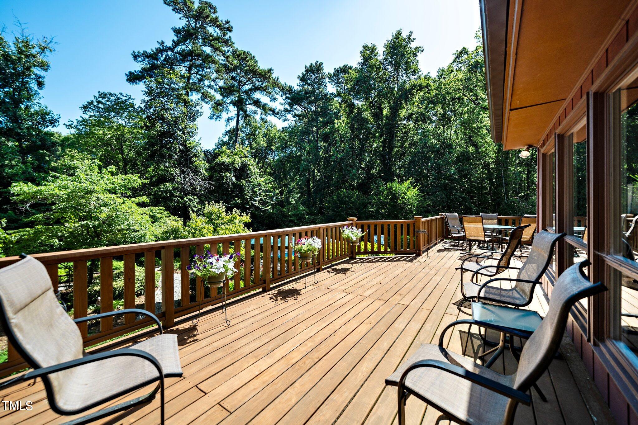 6406 Arnold Road Raleigh, NC 27607 - Photo 17 of 44 a balcony with wooden floor table and chairs
