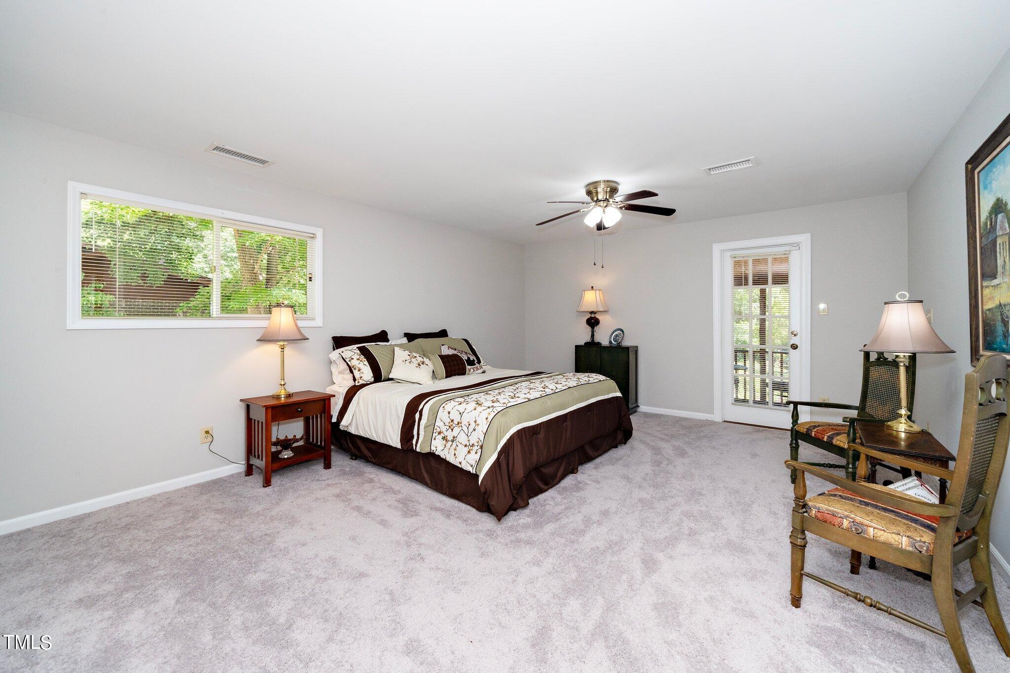 6406 Arnold Road Raleigh, NC 27607 - Photo 31 of 44 a bedroom with a bed and a chandelier