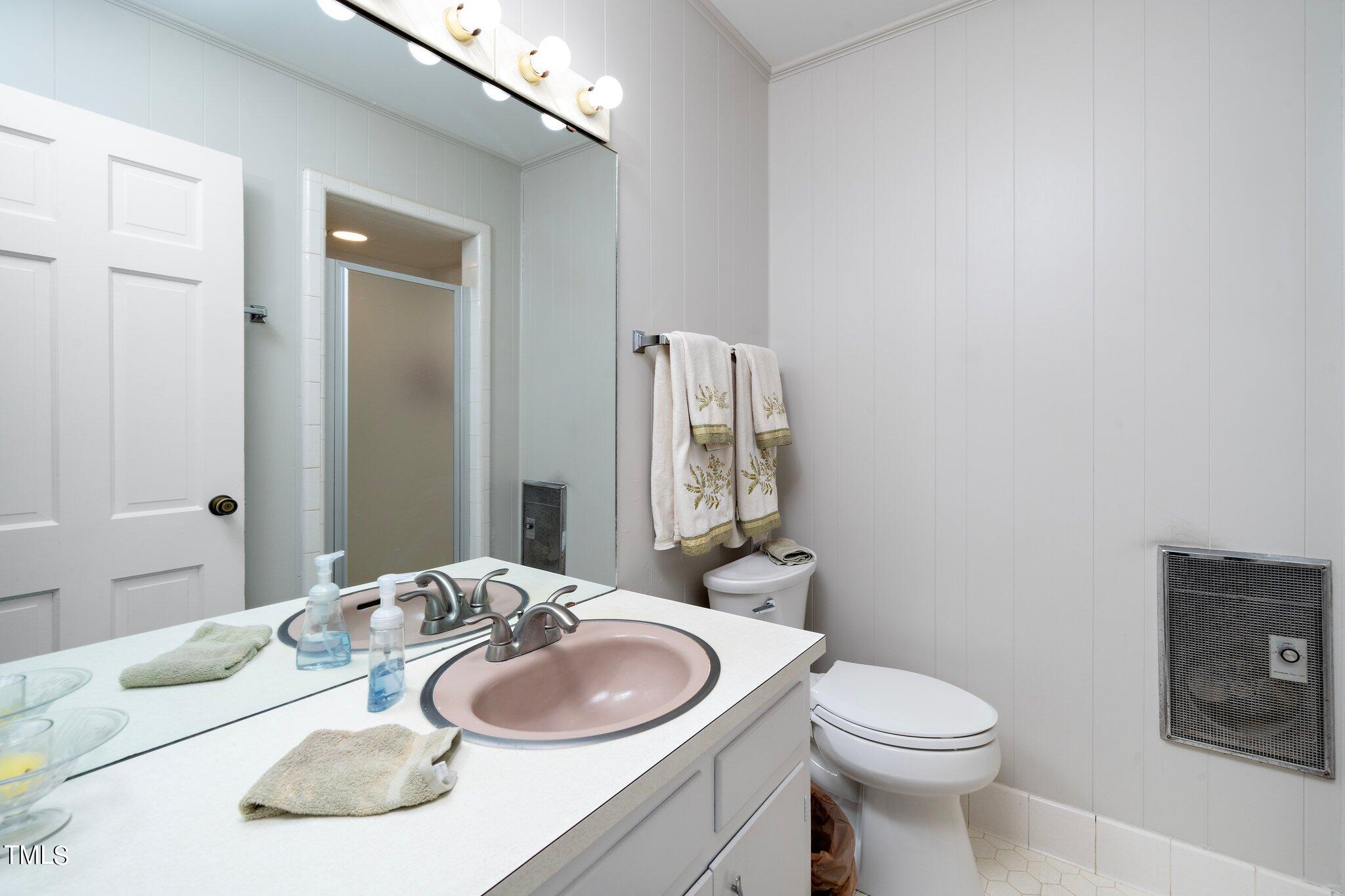 6406 Arnold Road Raleigh, NC 27607 - Photo 34 of 44 a bathroom with a granite countertop toilet and a sink