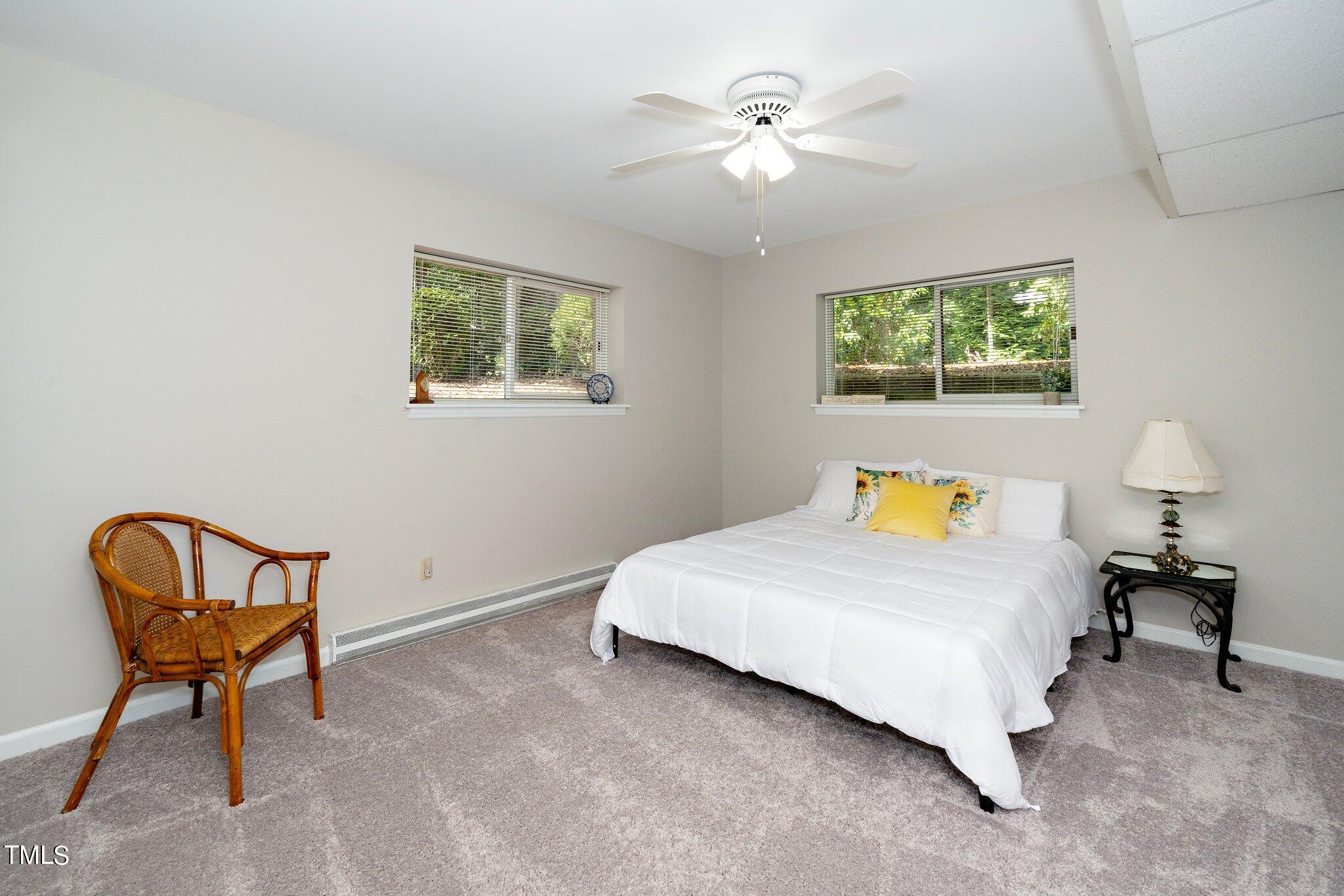 6406 Arnold Road Raleigh, NC 27607 - Photo 36 of 44 a bedroom with a bed chair and window