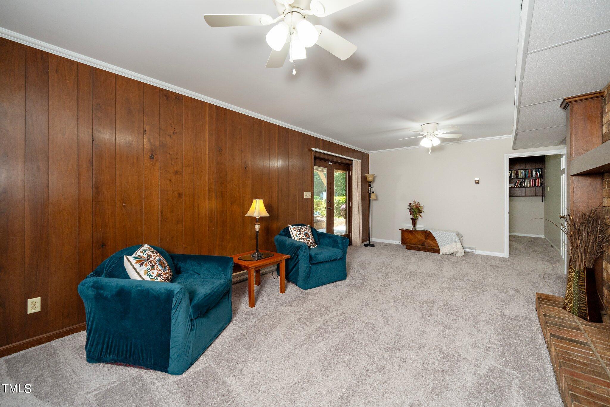 6406 Arnold Road Raleigh, NC 27607 - Photo 39 of 44 a living room with furniture and a flat screen tv