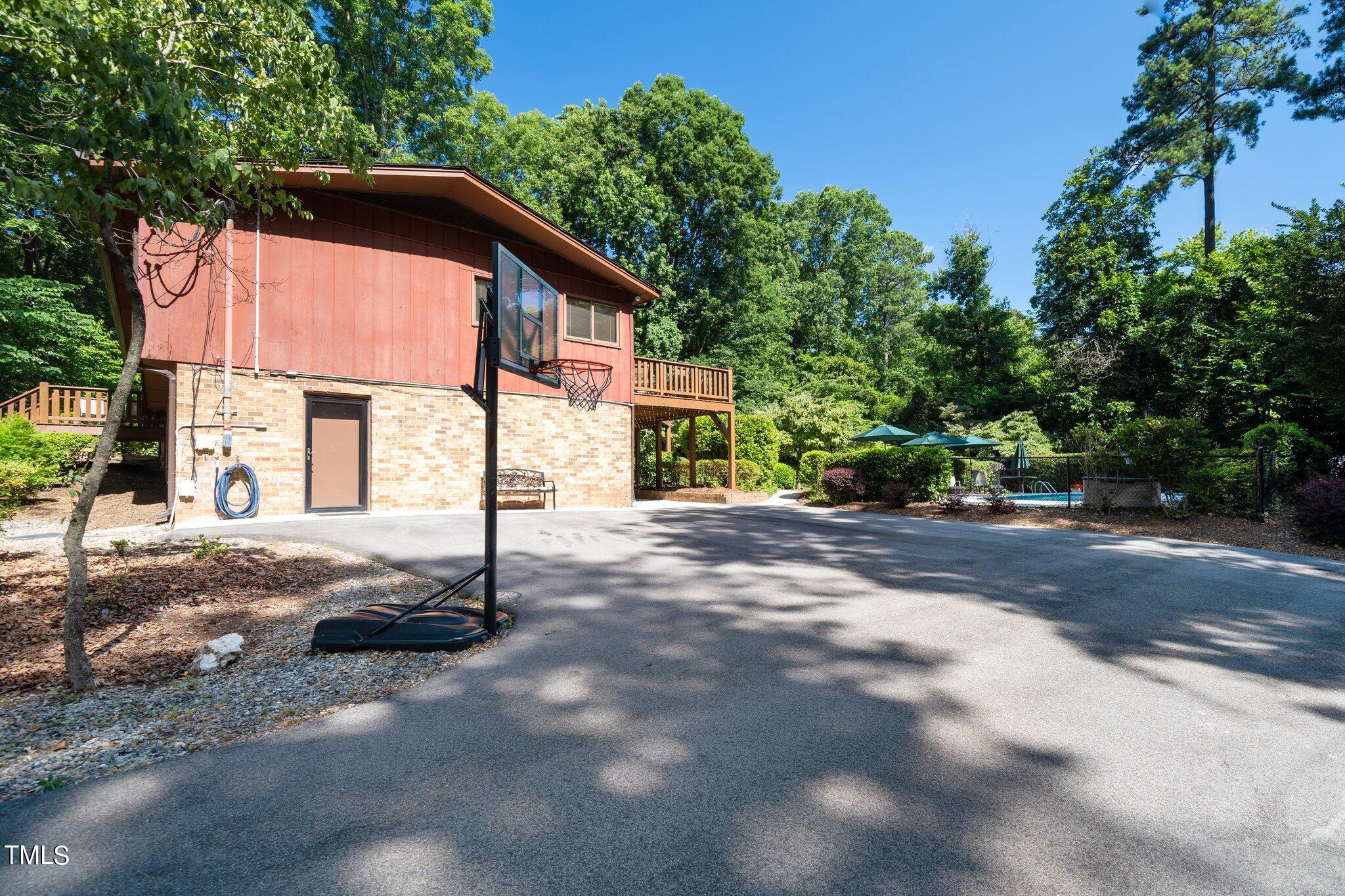 6406 Arnold Road Raleigh, NC 27607 - Photo 6 of 44 a view of a house with a yard and garage