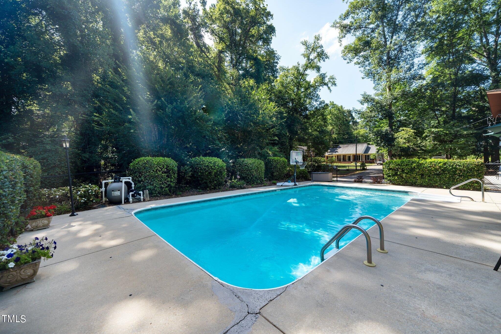 6406 Arnold Road Raleigh, NC 27607 - Photo 9 of 44 a view of a swimming pool with a patio and plants