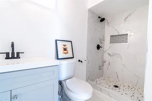 a bathroom with a toilet sink and shower