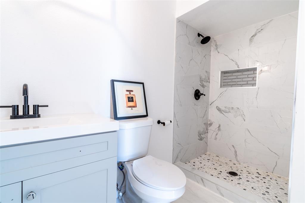 5000 Brandenburg Lane The Colony, TX 75056 - Photo 11 of 14 a bathroom with a toilet sink and shower