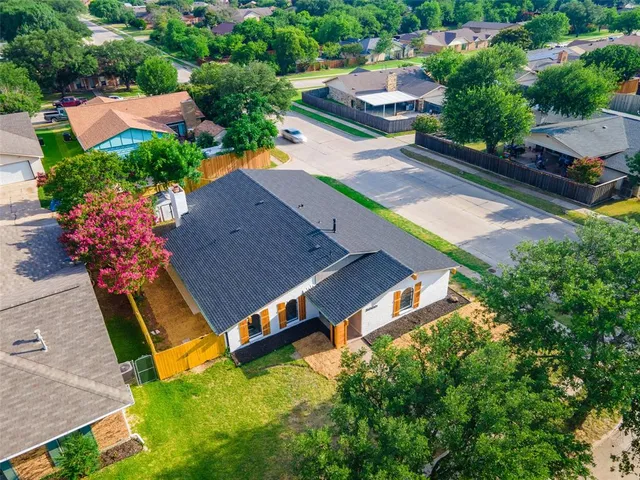 an aerial view of a house with garden space and street view