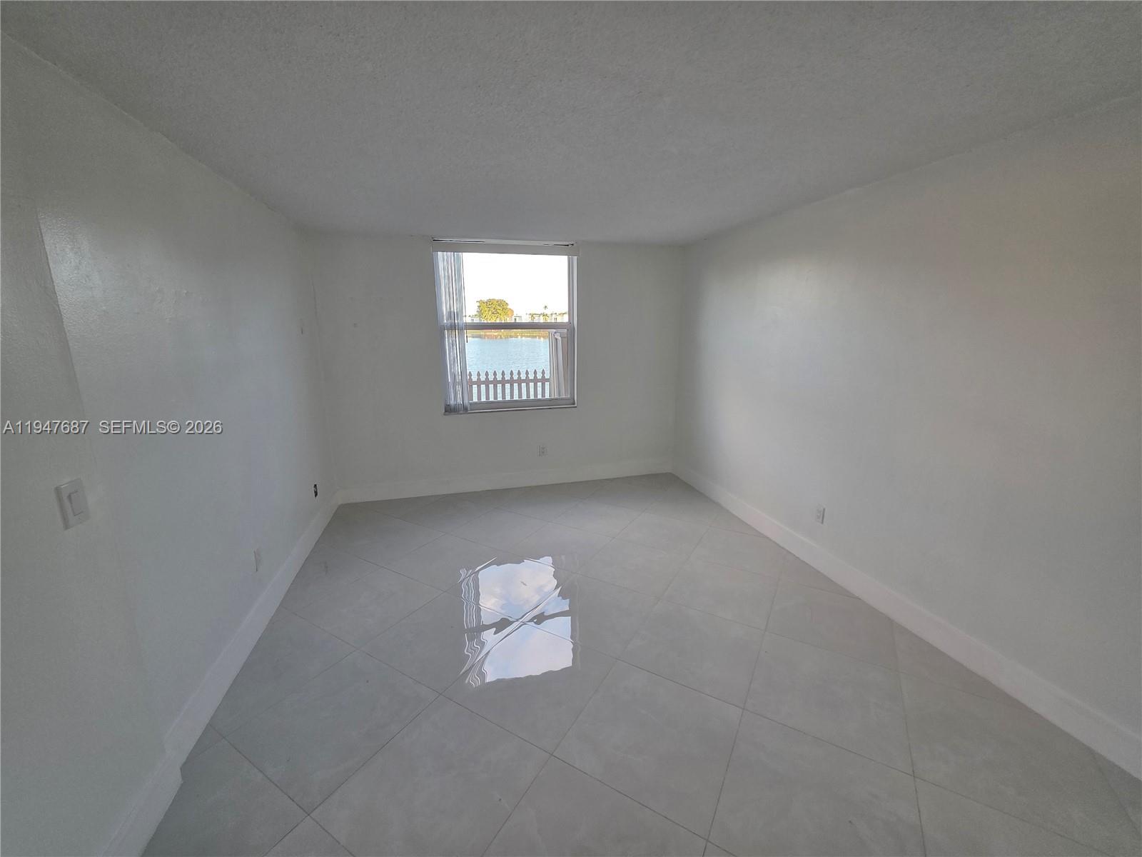 8307 Southwest 142nd Avenue, Unit E108 Miami, FL 33183 - Photo 11 of 22 a view of an empty room and a window