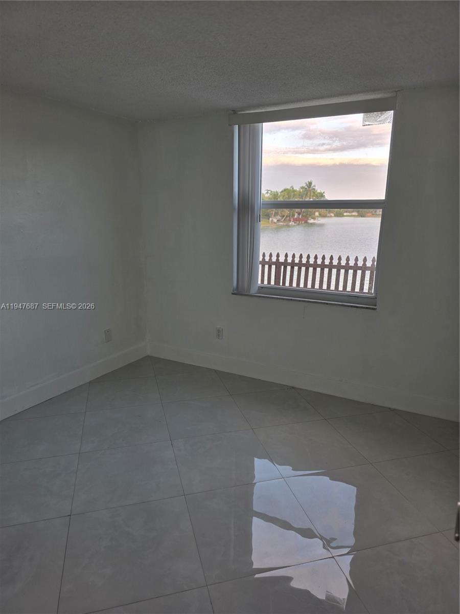 8307 Southwest 142nd Avenue, Unit E108 Miami, FL 33183 - Photo 15 of 22 a view of empty room with window