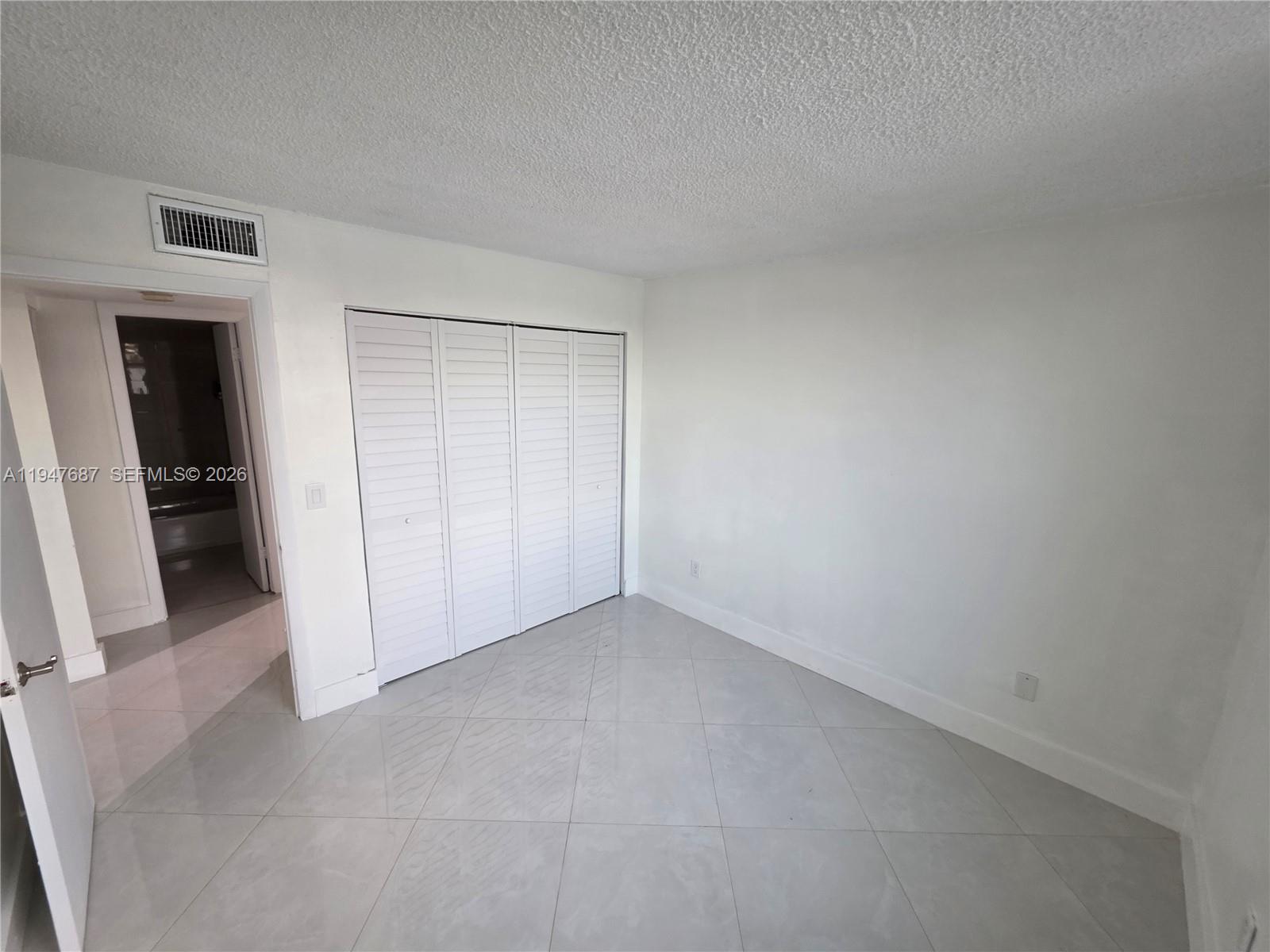 8307 Southwest 142nd Avenue, Unit E108 Miami, FL 33183 - Photo 16 of 22 an empty room with closet
