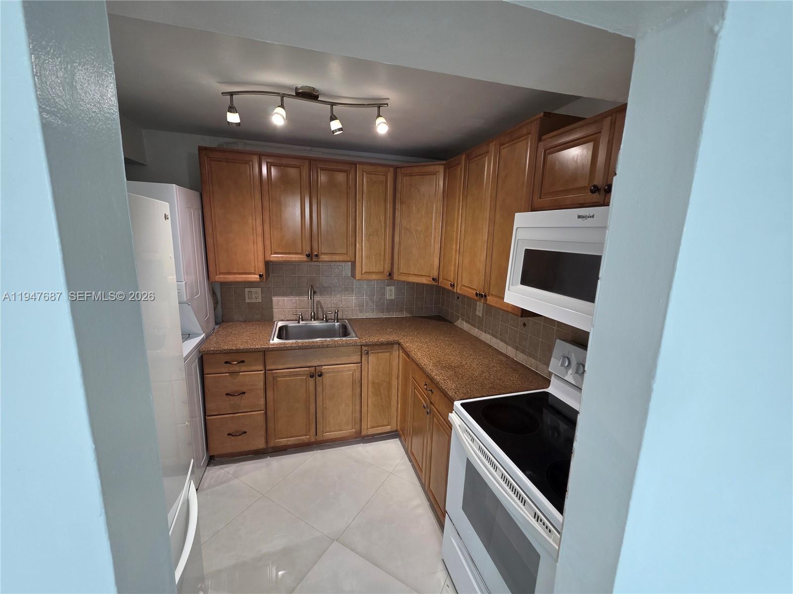 8307 Southwest 142nd Avenue, Unit E108 Miami, FL 33183 - Photo 22 of 22 a kitchen with sink and cabinets