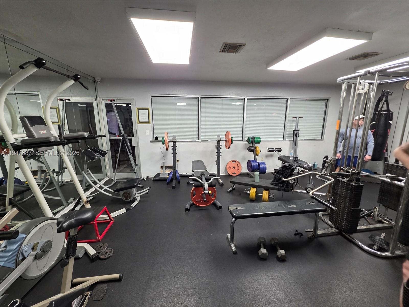 8307 Southwest 142nd Avenue, Unit E108 Miami, FL 33183 - Photo 5 of 22 a view of a room with gym equipment