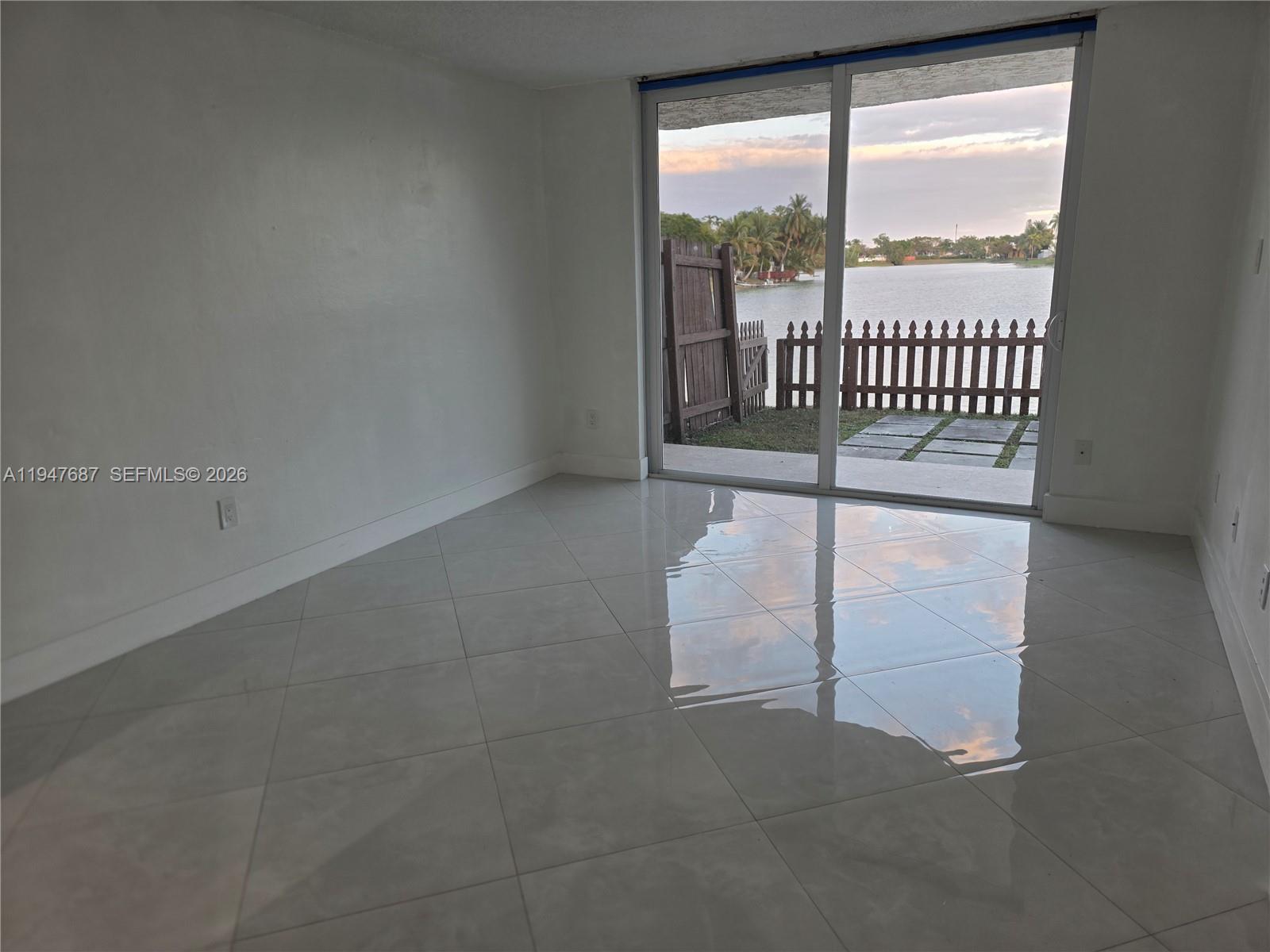 8307 Southwest 142nd Avenue, Unit E108 Miami, FL 33183 - Photo 7 of 22 an empty room with windows