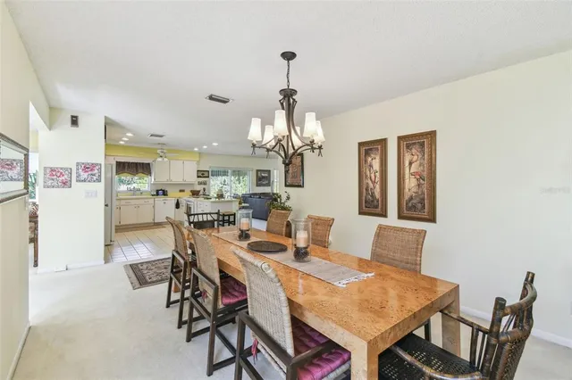 a view of a dining room with furniture and a chandelier