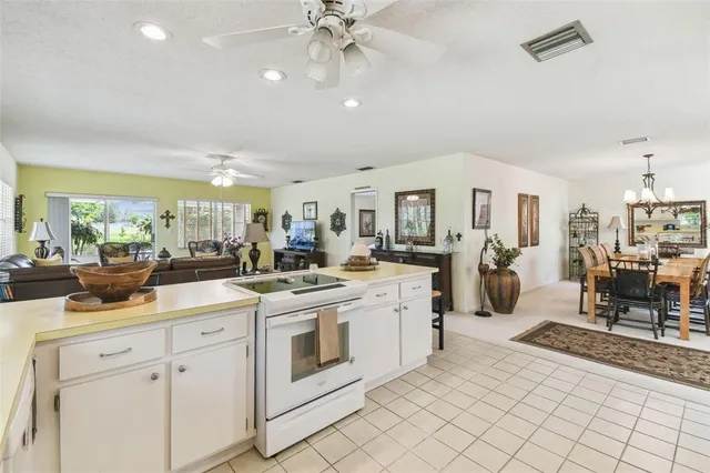a kitchen with stainless steel appliances kitchen island granite countertop a refrigerator and a stove top oven