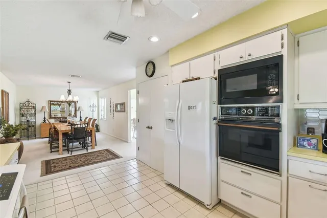a kitchen with a sink appliances and cabinets