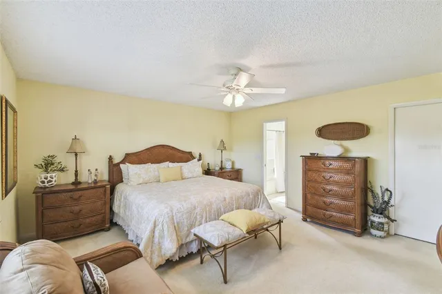 a bedroom with a large bed and dresser